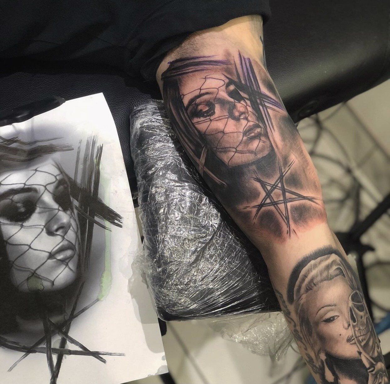 A person has a tattoo of a woman 's face on their arm