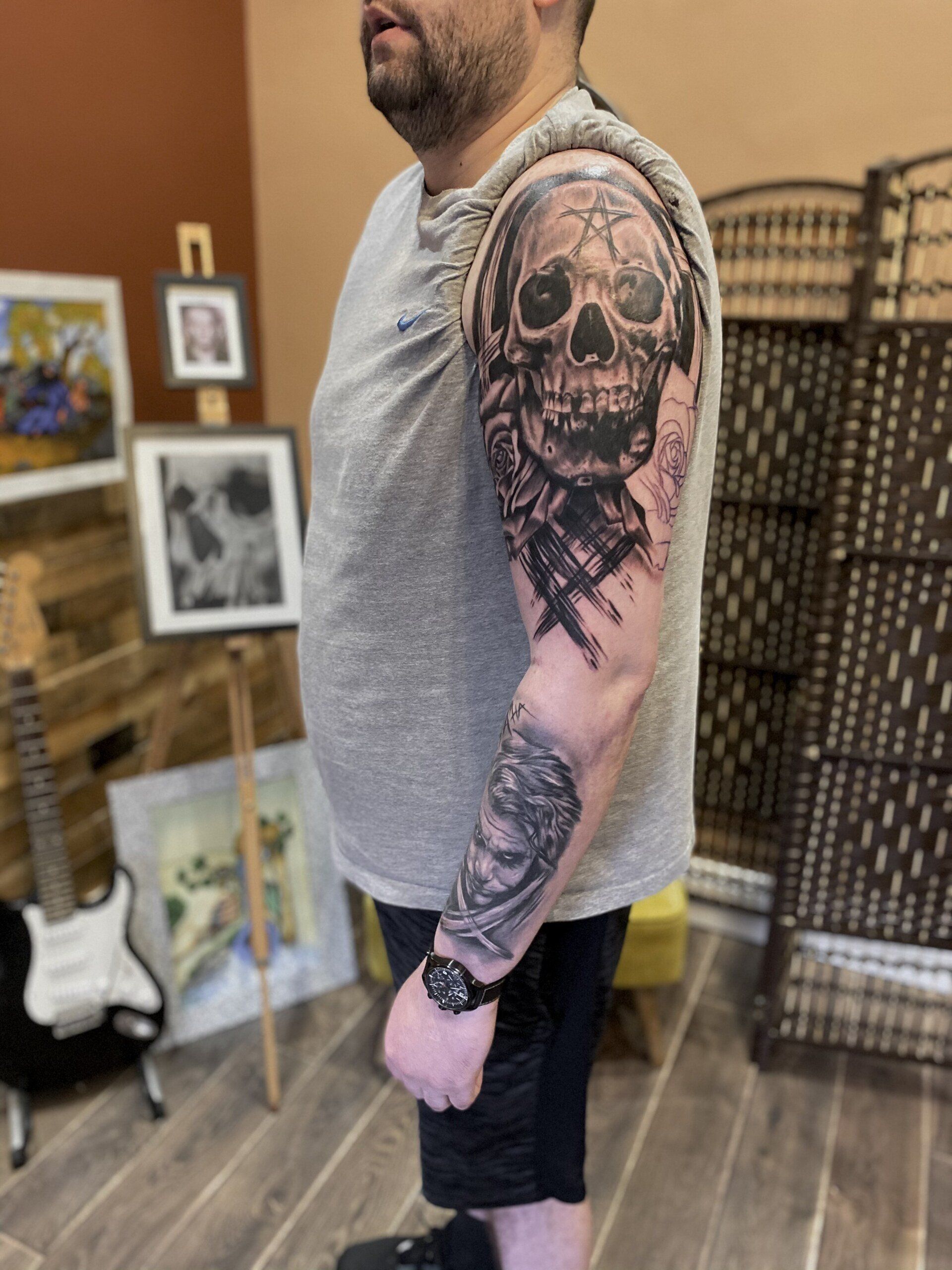 A man with a tattoo of a skull on his arm