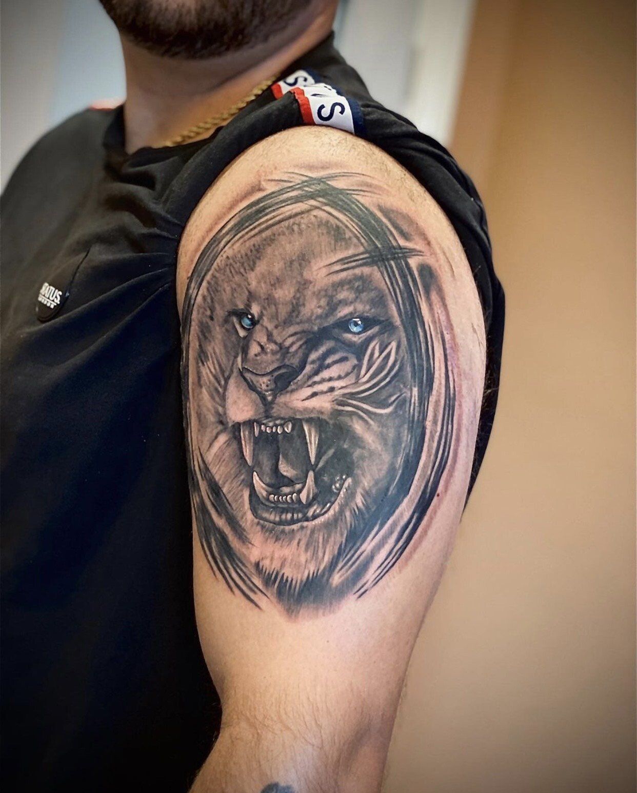 A man has a tattoo of a lion on his arm